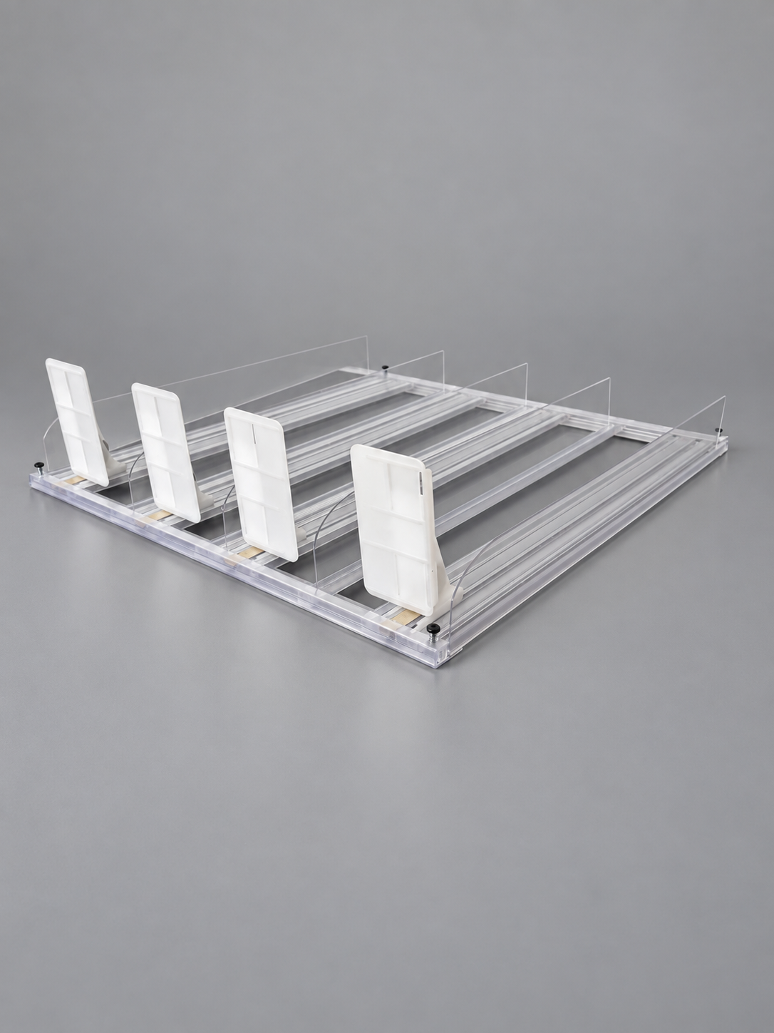 Compact pusher system assembled, photographed at three-quarter angle on grey, fully translucent